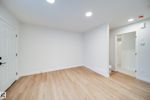 The room features light wood-style flooring, white walls, and recessed lighting in the ceiling - 9536 148 Street, Edmonton, AB - Indoor Photo Showing Other Room