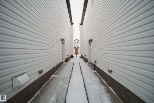 The property features white horizontal siding and a visible foundation - 9536 148 Street, Edmonton, AB - Outdoor With Exterior