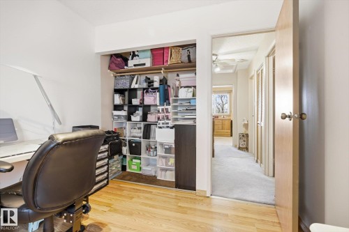 This room features hardwood flooring and a built-in closet with shelving - 3237 142 Avenue, Edmonton, AB - Indoor Photo Showing Office