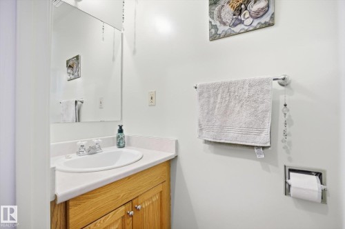 Bathroom featuring a vanity with a light wood base and a white countertop - 3237 142 Avenue, Edmonton, AB - Indoor Photo Showing Bathroom