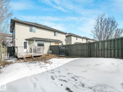 The property features a fenced backyard with a wooden deck - 675 Mcallister Loop, Edmonton, AB - Outdoor