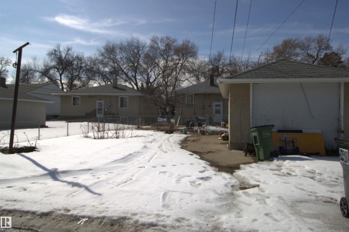 The property features a sloped roof and an exterior with light-colored siding - 12221 94 Street, Edmonton, AB - Outdoor