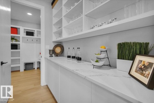 This property features a bright and organized space with white cabinetry and shelving, complemented by a light-colored countertop - 207 Starling, Fort Saskatchewan, AB - Indoor