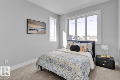 This room features broadloom carpet and light-colored walls - 207 Starling, Fort Saskatchewan, AB - Indoor Photo Showing Bedroom