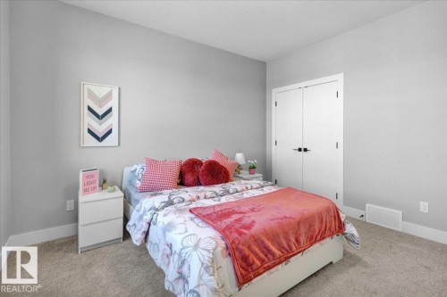 This room features light grey walls, carpeted flooring, and a white baseboard trim - 207 Starling, Fort Saskatchewan, AB - Indoor Photo Showing Bedroom