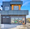 The property features a contemporary architectural style with dark grey paneling and wood-look accents - 207 Starling, Fort Saskatchewan, AB  - Outdoor 