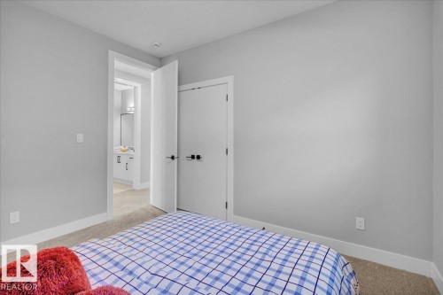 The property features light gray walls, white trim, and carpeted flooring - 207 Starling, Fort Saskatchewan, AB - Indoor Photo Showing Bedroom