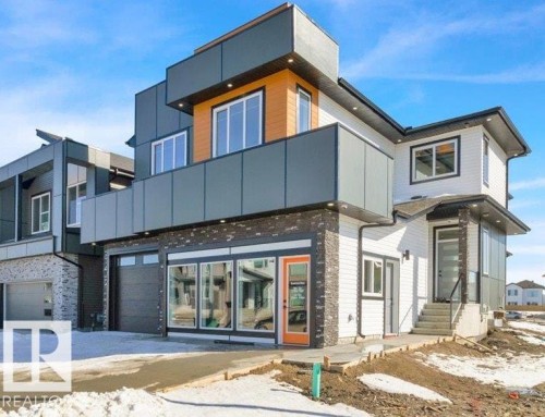 The property features a modern exterior with a mix of white siding, dark grey panels, and stone accents - 207 Starling, Fort Saskatchewan, AB - Outdoor