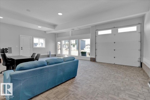 Spacious room with light-colored walls and recessed lighting - 207 Starling, Fort Saskatchewan, AB - Indoor Photo Showing Garage