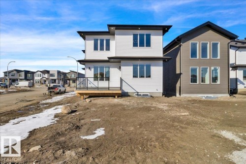 The property features a contemporary architectural style with white siding and dark trim - 207 Starling, Fort Saskatchewan, AB - Outdoor