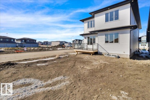 This property features a two-story exterior with light-colored siding and dark trim - 207 Starling, Fort Saskatchewan, AB - Outdoor