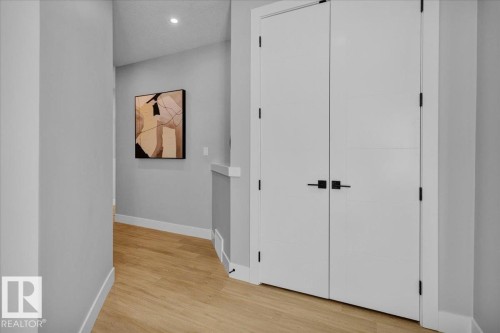 Hallway featuring light-toned flooring, white trim, and a recessed ceiling light - 207 Starling, Fort Saskatchewan, AB - Indoor Photo Showing Other Room