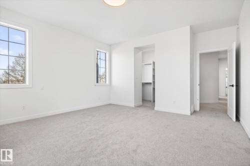 This room features light grey carpeting, white walls, and two windows with white frames - 9705 68 Avenue, Edmonton, AB - Indoor Photo Showing Other Room