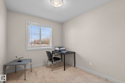 This room features a window with blinds, carpeted flooring, and neutral-toned walls - 