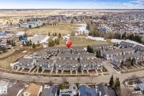 Aerial view of the property and its surrounding area, featuring paved roads and residential buildings - 24 4205 30 Street, Edmonton, AB - Outdoor With View