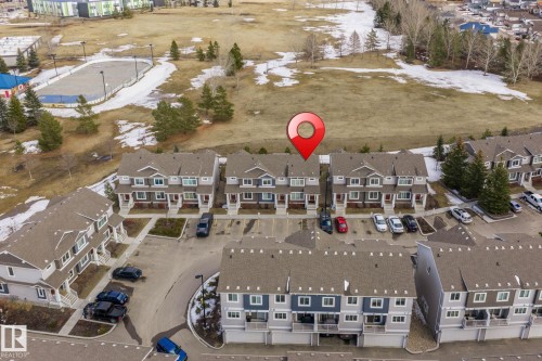 Aerial view of the property and its surrounding area, featuring paved parking areas, green spaces, and an outdoor court - 24 4205 30 Street, Edmonton, AB - Outdoor With View