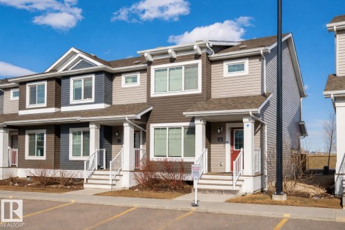 The property features an attractive exterior with multi-toned siding, white window frames, and white porch columns - 24 4205 30 Street, Edmonton, AB - Outdoor With Facade