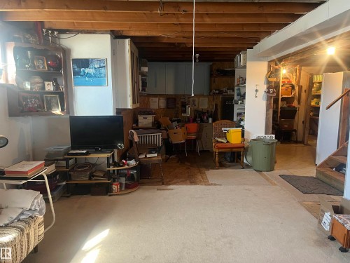 This versatile lower level features exposed ceiling beams and a partial carpeted floor - 55131 Range Road 83, Rural Yellowhead, AB - Indoor