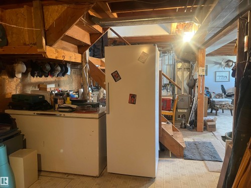 The property features visible wooden structural beams and a wooden staircase - 55131 Range Road 83, Rural Yellowhead, AB - Indoor Photo Showing Basement