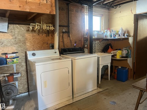 This utility area includes a washer and dryer, a utility sink, and a window providing natural light - 55131 Range Road 83, Rural Yellowhead, AB - Indoor Photo Showing Laundry Room