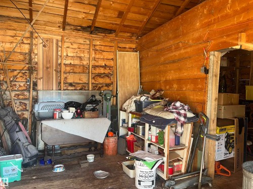 The property features exposed wooden beam ceilings and wood-paneled walls - 55131 Range Road 83, Rural Yellowhead, AB - Indoor Photo Showing Other Room