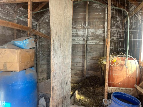 The property includes a rustic outbuilding with wooden walls and structural beams - 55131 Range Road 83, Rural Yellowhead, AB - Indoor Photo Showing Bathroom