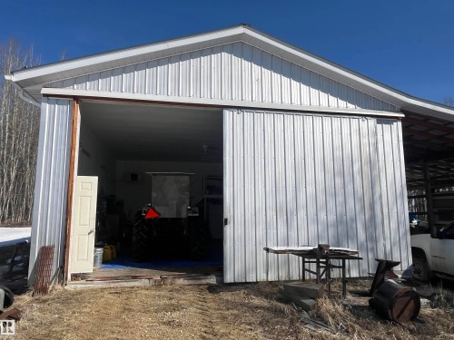 This property features a spacious metal outbuilding with a large sliding door entrance, providing expansive access - 55131 Range Road 83, Rural Yellowhead, AB - Outdoor With Exterior