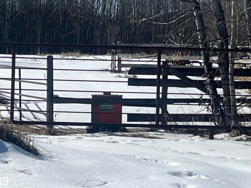 The property features a metal gate, with a wooden gate also visible - 55131 Range Road 83, Rural Yellowhead, AB -  With View