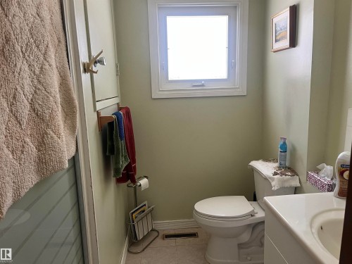 Bathroom featuring a window, toilet, and vanity with a sink - 55131 Range Road 83, Rural Yellowhead, AB - Indoor Photo Showing Bathroom