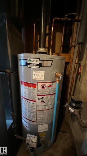 Hot water heater with visible piping and gauges - 3323 107 Avenue Nw, Edmonton, AB - Indoor Photo Showing Basement