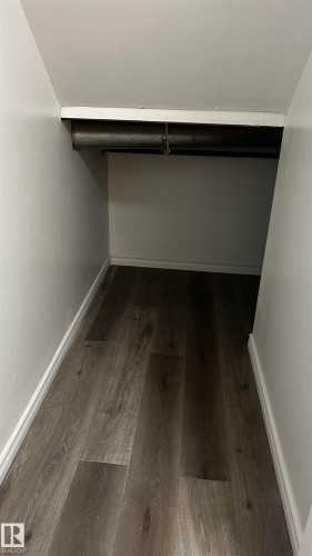Storage area featuring wood-style flooring and white painted walls - 3323 107 Avenue Nw, Edmonton, AB - Indoor