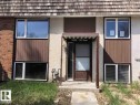 The property features a combination of brick and textured stucco siding, alongside brown vertical paneling - 3323 107 Avenue Nw, Edmonton, AB  - Outdoor 