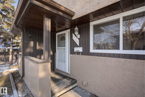 The property features a front entrance with a white storm door, an exterior wall light fixture, and a mailbox - 1706 37 Street, Edmonton, AB - Outdoor With Exterior