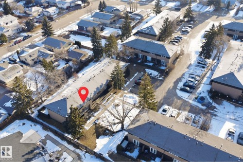 This property is part of a residential complex featuring multiple buildings with dark roofs and light-colored facades - 1706 37 Street, Edmonton, AB - Outdoor With View