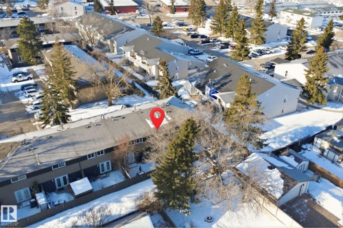 The property features a multi-unit structure with a dark-colored roof and light-colored exterior walls - 1706 37 Street, Edmonton, AB - Outdoor With View