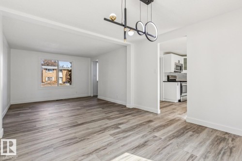 The property features bright white walls, contemporary lighting fixtures, and light-toned flooring - 95 Ridgewood Terrace, St. Albert, AB - Indoor Photo Showing Living Room