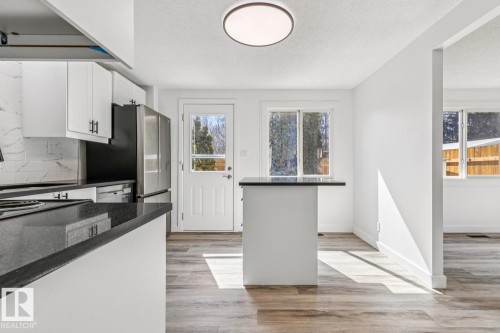 Kitchen with white cabinetry, dark countertops, and stainless steel appliances - 95 Ridgewood Terrace, St. Albert, AB - Indoor Photo Showing Kitchen