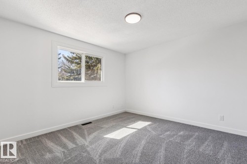 Room featuring light gray patterned carpeting, white walls, and a window providing natural light - 95 Ridgewood Terrace, St. Albert, AB - Indoor Photo Showing Other Room