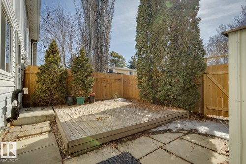 The property features a wooden deck and paved patio area, enclosed by a wooden fence - 95 Ridgewood Terrace, St. Albert, AB - Outdoor