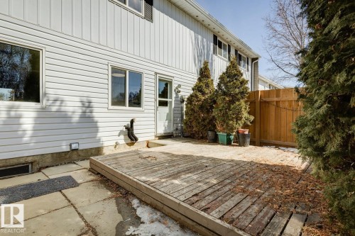 The property features a private outdoor area with a wooden deck, a paved patio, and a wooden fence - 95 Ridgewood Terrace, St. Albert, AB - Outdoor With Exterior