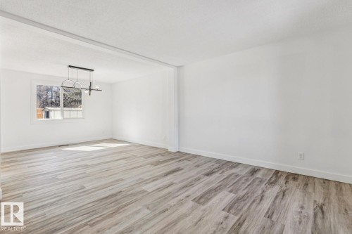 Spacious room featuring light-colored flooring, white walls, and a modern ceiling light fixture - 95 Ridgewood Terrace, St. Albert, AB - Indoor Photo Showing Other Room
