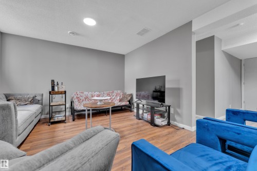 Living area featuring wood-look flooring and light gray walls - 3609 11 Street, Edmonton, AB - Indoor Photo Showing Living Room
