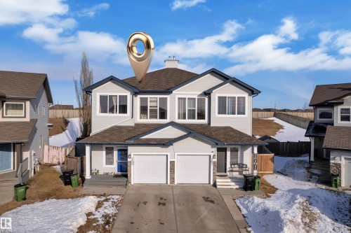 The property features a two-story design with light-colored siding and dark trim - 3609 11 Street, Edmonton, AB - Outdoor