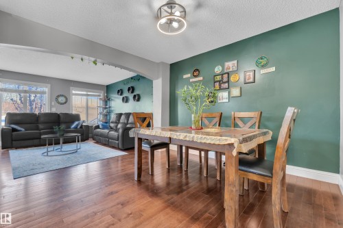 The property features an open-concept living and dining area with hardwood floors - 3609 11 Street, Edmonton, AB - Indoor Photo Showing Other Room