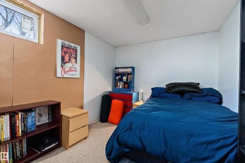 This room features a window providing natural light, white and brown walls, and a light-colored carpet - 28 Camelot Avenue, Leduc, AB - Indoor Photo Showing Bedroom