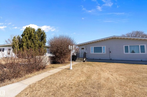 The property features a ranch-style exterior with light gray siding and white trim - 28 Camelot Avenue, Leduc, AB - Outdoor