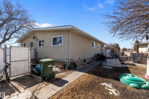 The property features a light-colored stucco exterior with white window frames - 28 Camelot Avenue, Leduc, AB - Outdoor With Exterior