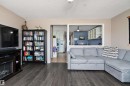 Living area featuring dark wood-style flooring, a ceiling fan, and a built-in media console with an electric fireplace - 28 Camelot Avenue, Leduc, AB  - Indoor Photo Showing Living Room 