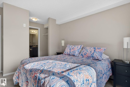 Bedroom featuring neutral-toned walls and carpeted flooring - 215 1080 Mcconachie Boulevard, Edmonton, AB - Indoor Photo Showing Bedroom