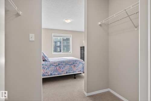 Bedroom with carpeting, a window, and a ceiling light fixture - 215 1080 Mcconachie Boulevard, Edmonton, AB - Indoor With Storage